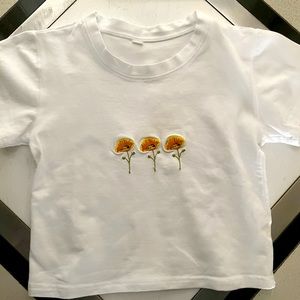 A cute white t- shirt with flowers.